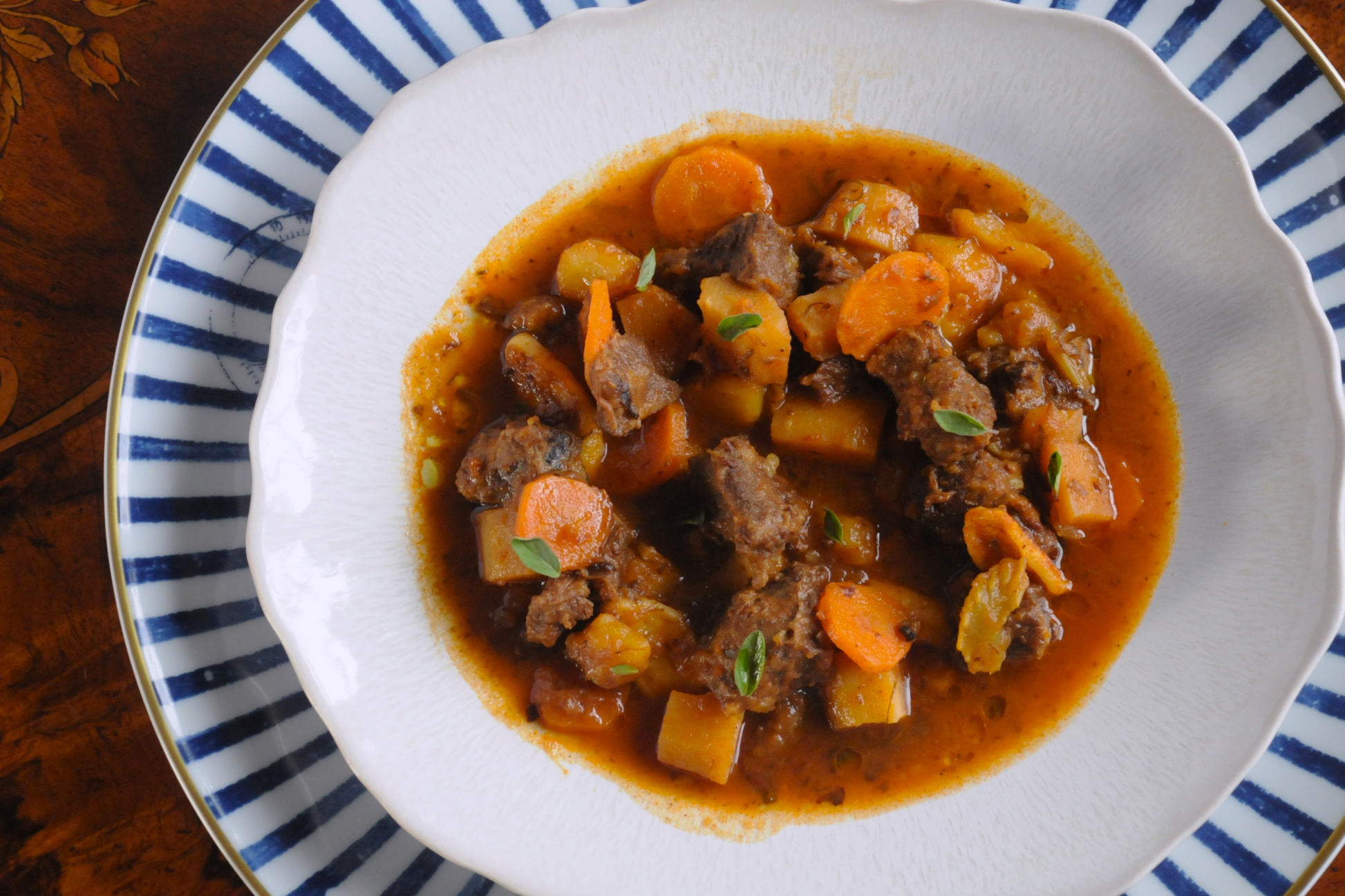 Overhead view of beef cheek goulash with root vegetables, chef-prepared in the Algarve