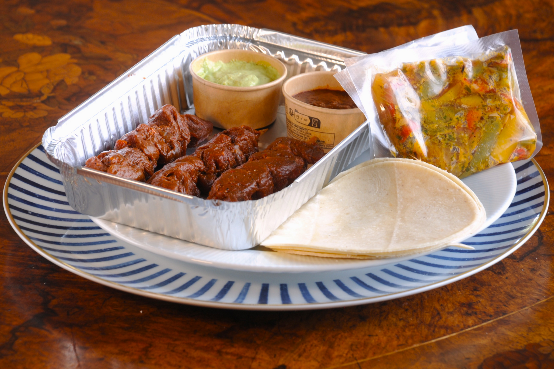 Frozen DIY Mexican taco kit as delivered — marinated beef skewers, tortillas, peppers and avocado crema