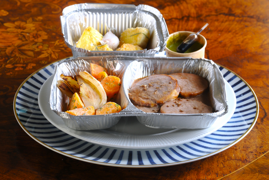 chef ready to eat lamb shoulder with roast vegetables and mint salsa
