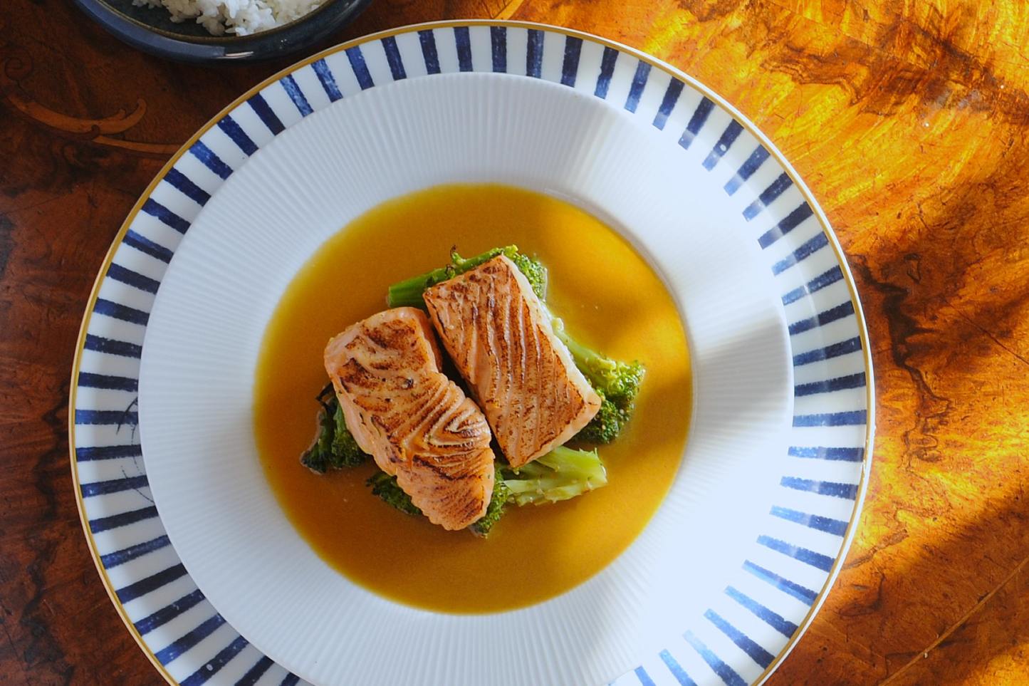Miso glazed salmon fillet and broccoli in a ready meal tray before cooking
