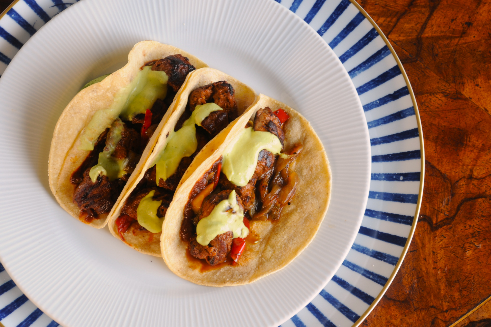 Adobo Beef Taco kit, frozen ready meal delivered across the Algarve — overhead view with avocado crema and grilled peppers